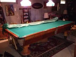 Does sitting on a pool table damage it?